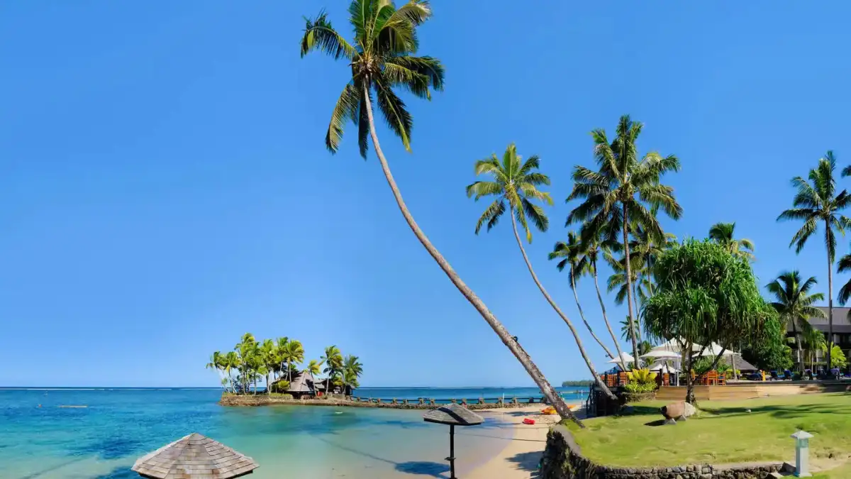 Palm-lined Fiji resort beside a calm blue lagoon