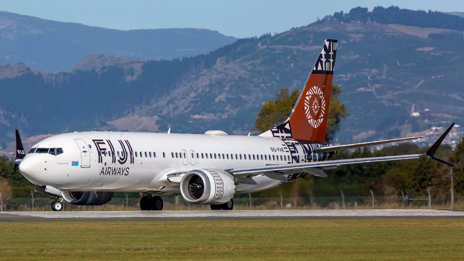 Fiji Airways aircraft at Nadi International Airport, with hills in the background