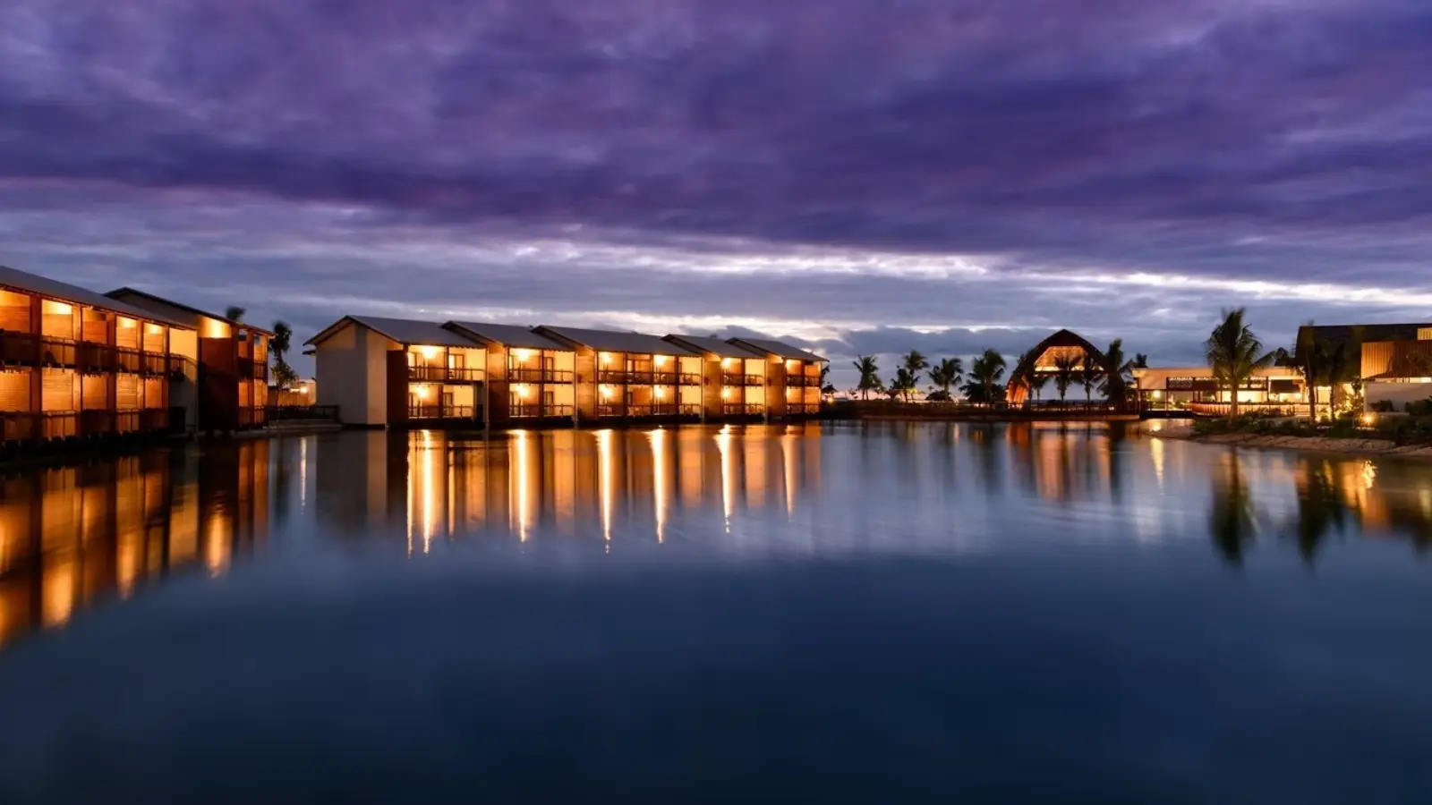 Fiji beach sunset with palm trees and affordable ocean bungalows showing budget-friendly paradise vibes