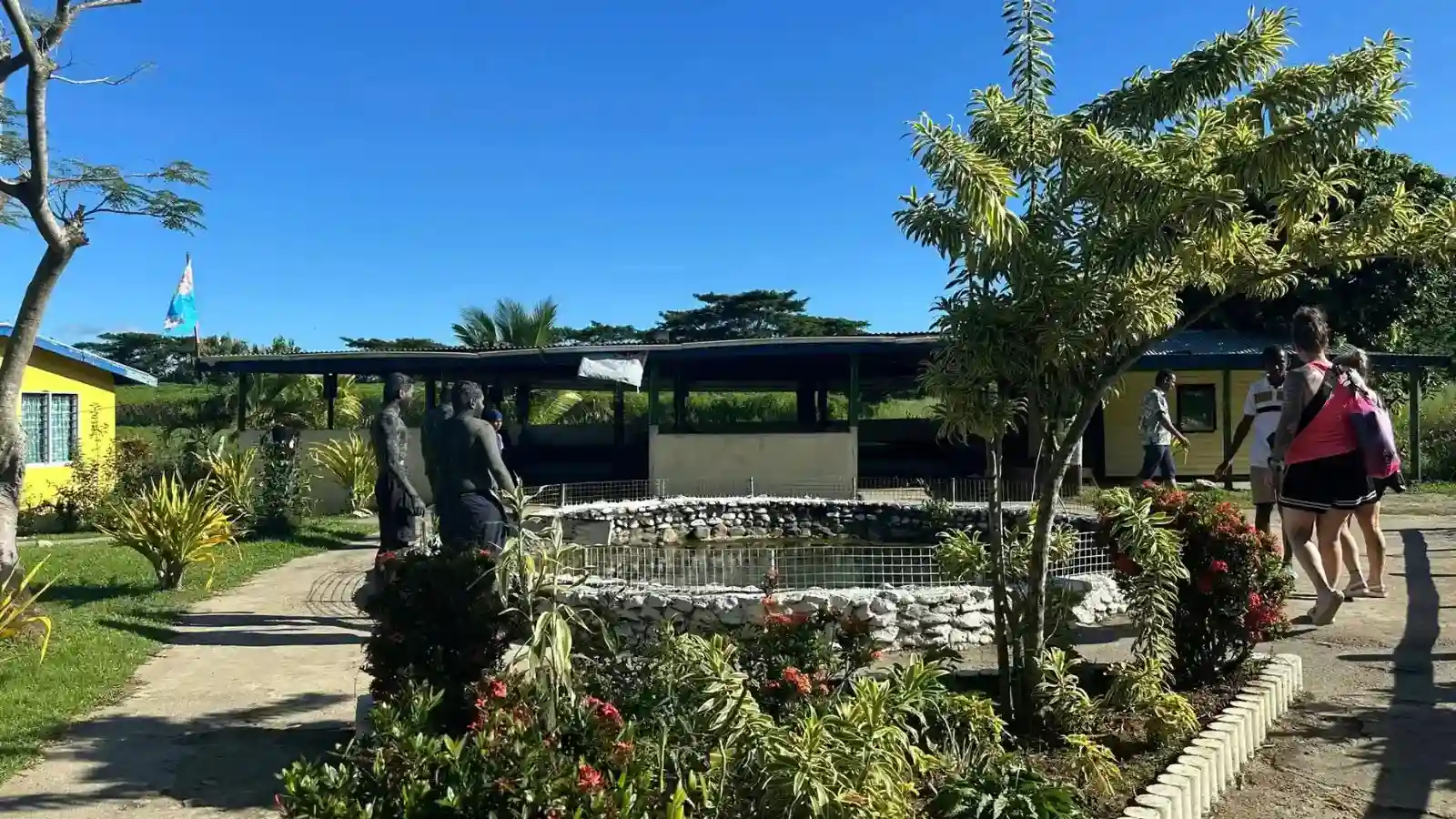 Visitors covered in therapeutic volcanic mud at Sabeto Hot Springs with natural geothermal pools and lush tropical rainforest near Nadi Fiji