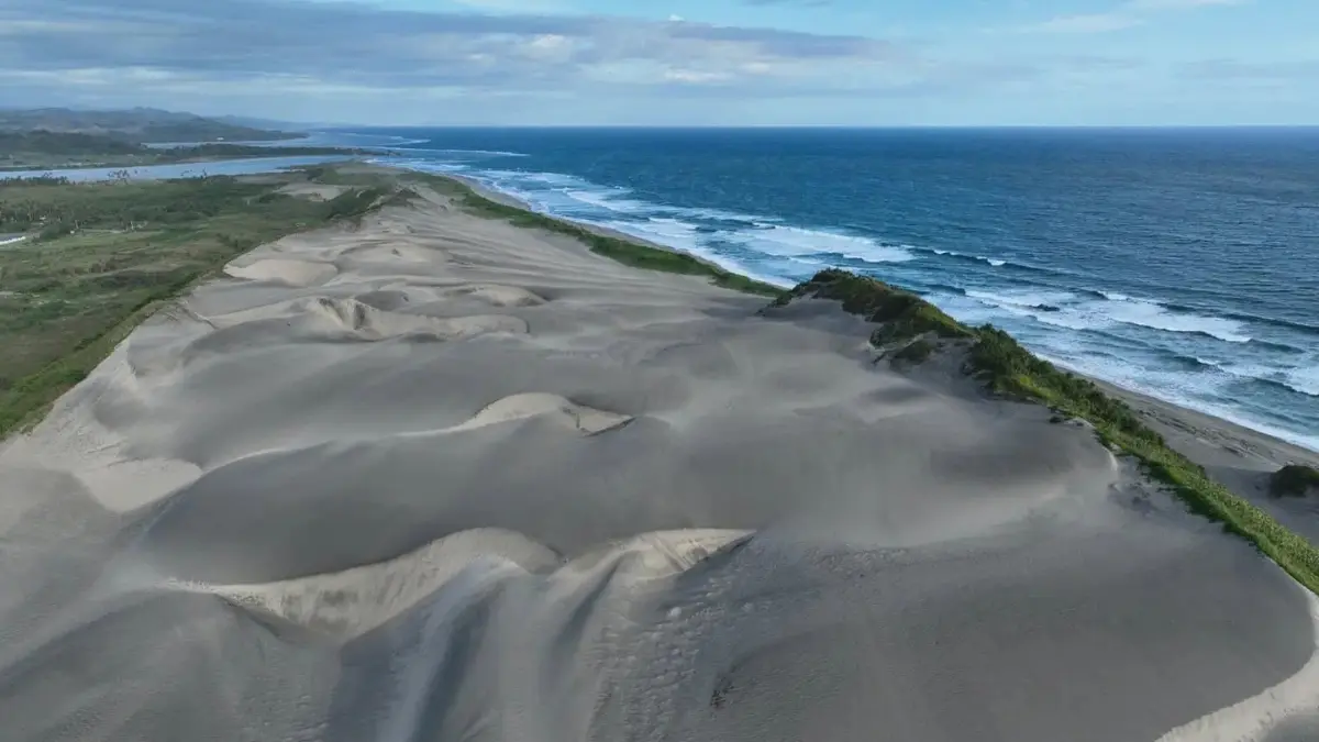 Wind-shaped dunes and coastal vegetation along a walking trail in Sigatoka Sand Dunes National Park