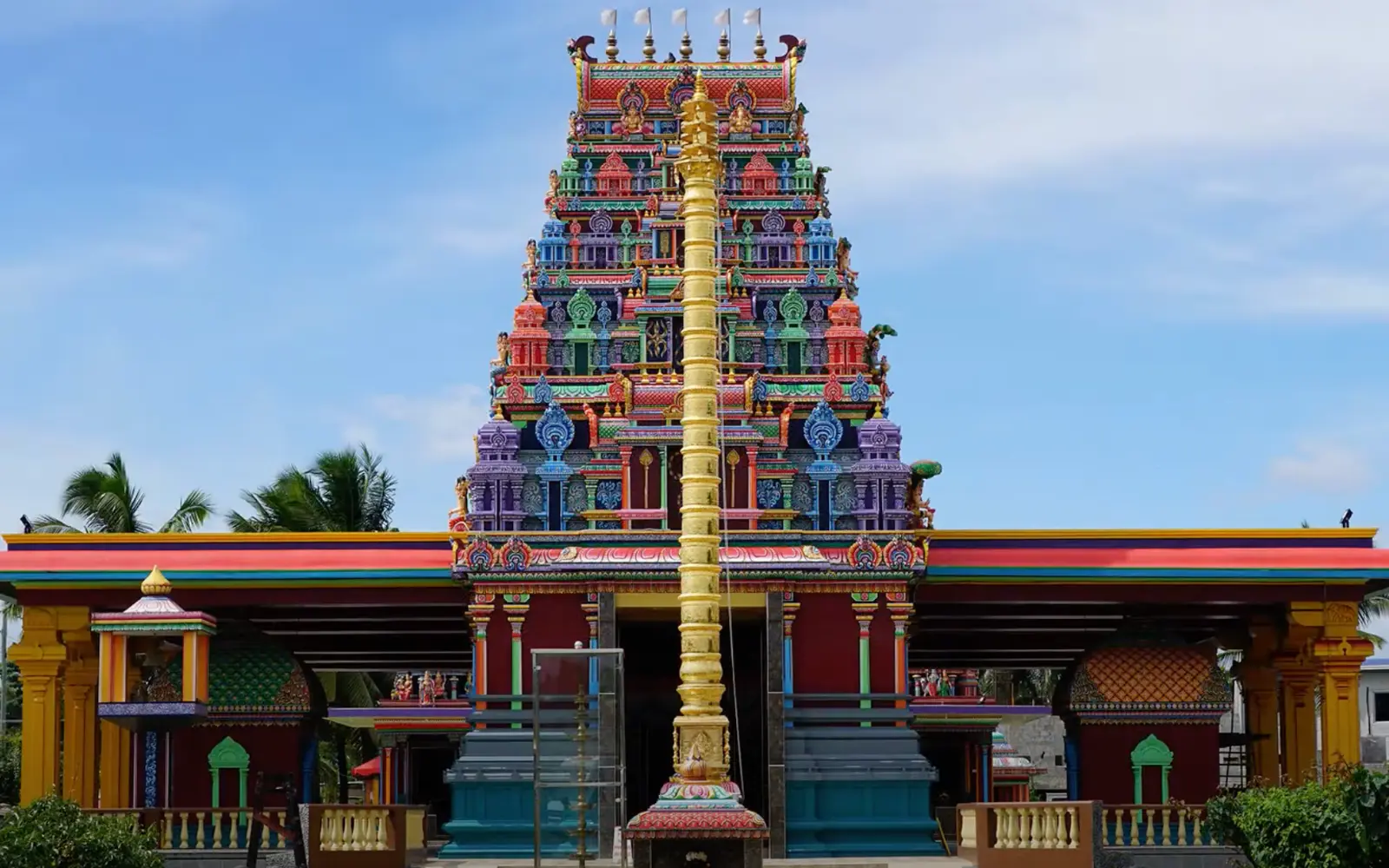 Colorful entrance tower and golden ceremonial pillar at Sri Siva Subramaniya Temple in Nadi