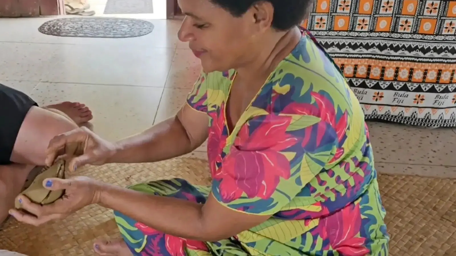 Woman shaping clay by hand during a pottery demonstration