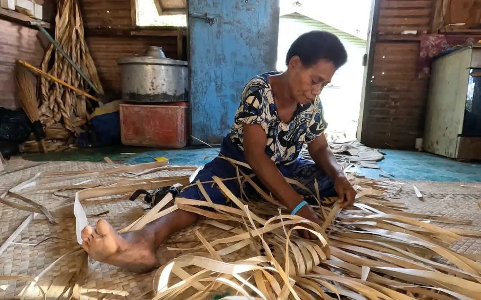 Fijian women weaving baskets in a village workshop