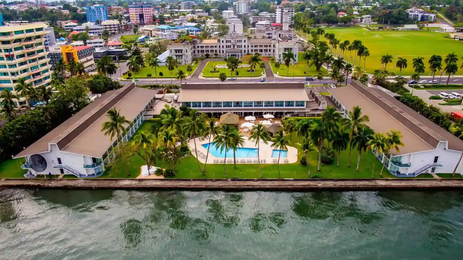 Colonial-era Indo-Saracenic Government Buildings along Victoria Parade in Suva, framed by tropical palms and showcasing British colonial architectural design