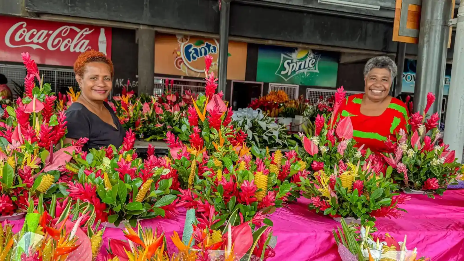 Vibrant flower stall at Suva Municipal Market showcasing tropical flowers and multicultural vendors representing Fiji’s cultural diversity