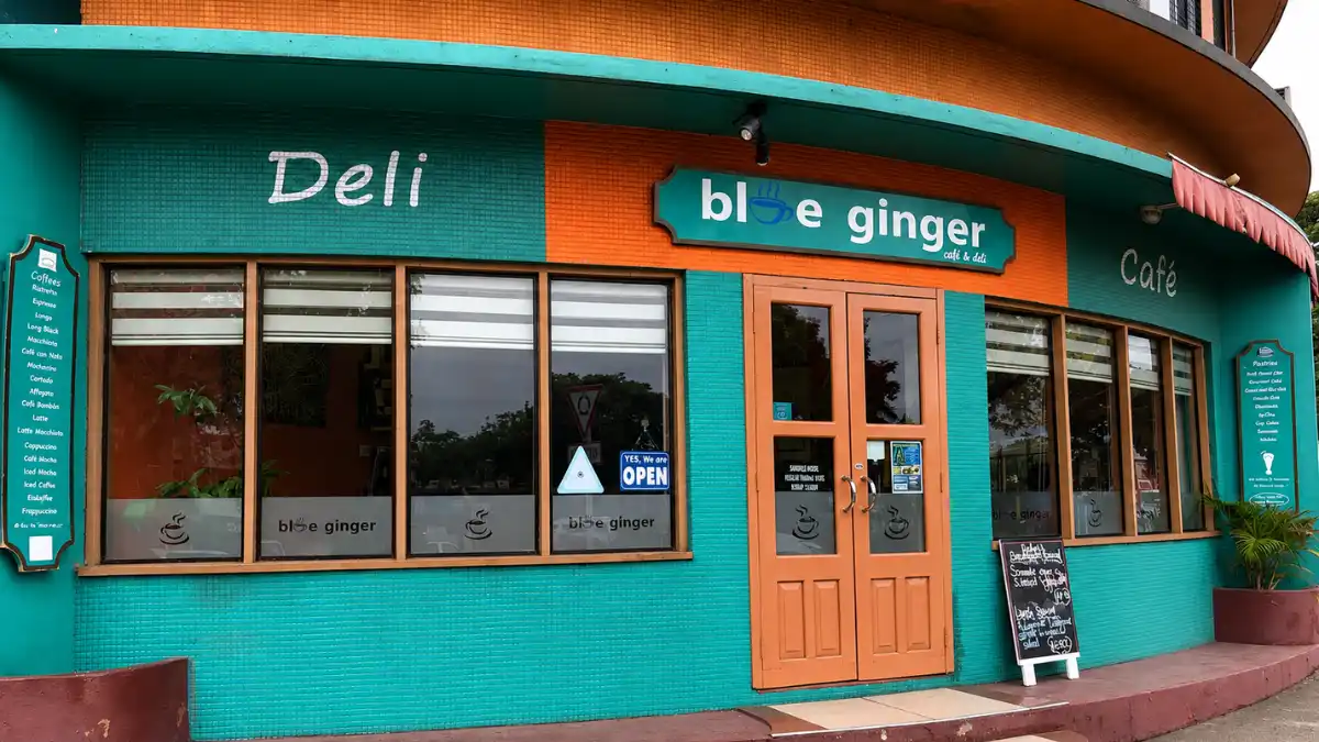 Turquoise and orange exterior of Blue Ginger Café & Deli in Lautoka with the café sign above the entrance.