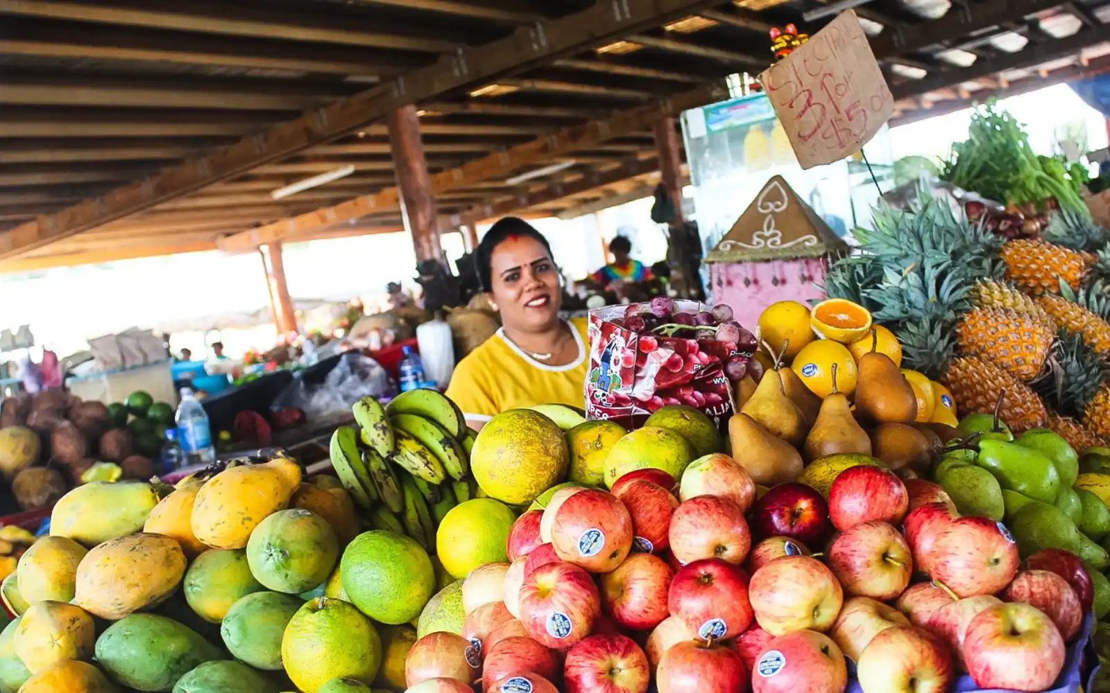 Colorful produce stalls at Sigatoka Food Market with taro and pineapples