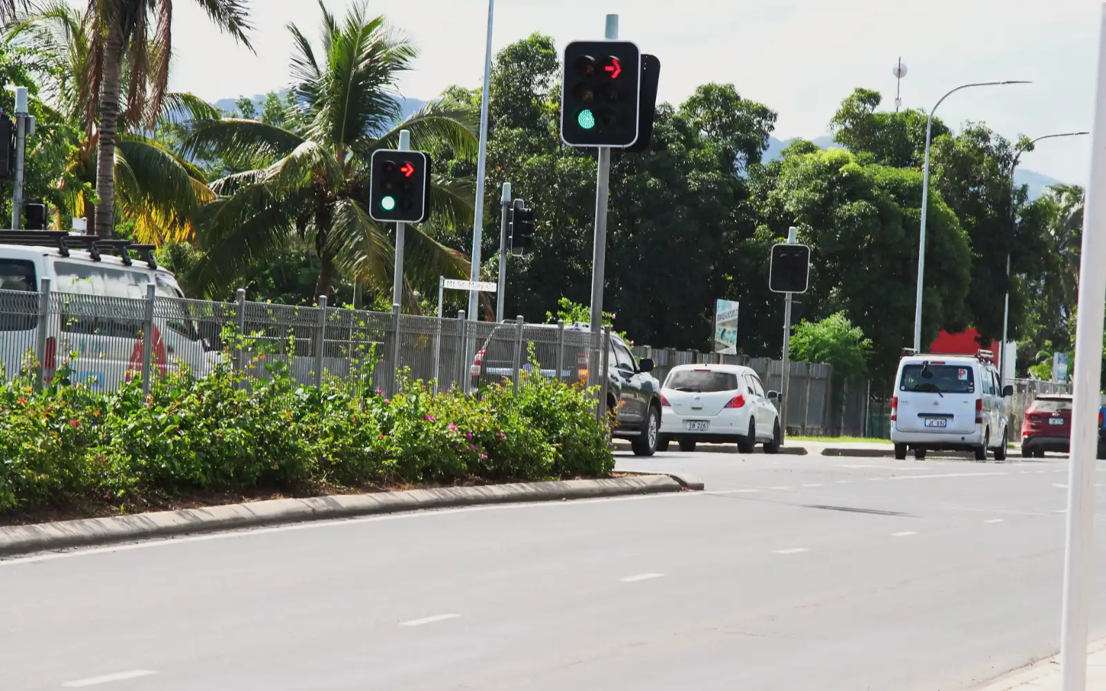 Scenic coastal view of Queen's Road in Fiji, showing clear road winding along the ocean, suggesting a picturesque drive to Suva.