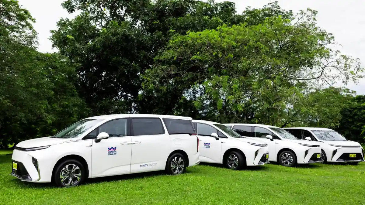 Four white TEWAKA Maxus MIFA 9 electric vehicles lined up in Nadi, Fiji