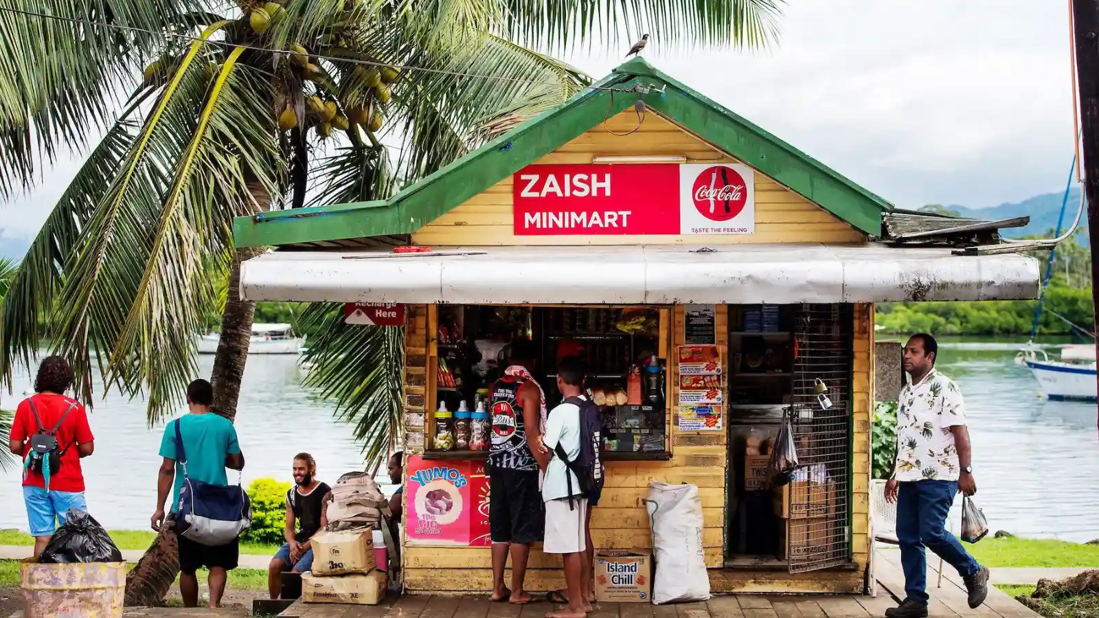 Savusavu farmers market stalls with colorful tropical fruits, fresh vegetables, and local vendors under covered structure