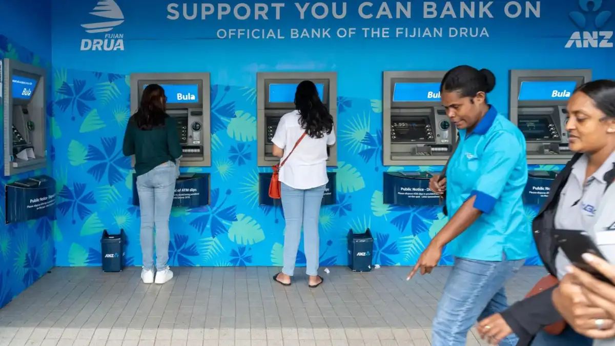 People using a row of ANZ cash machines in Fiji