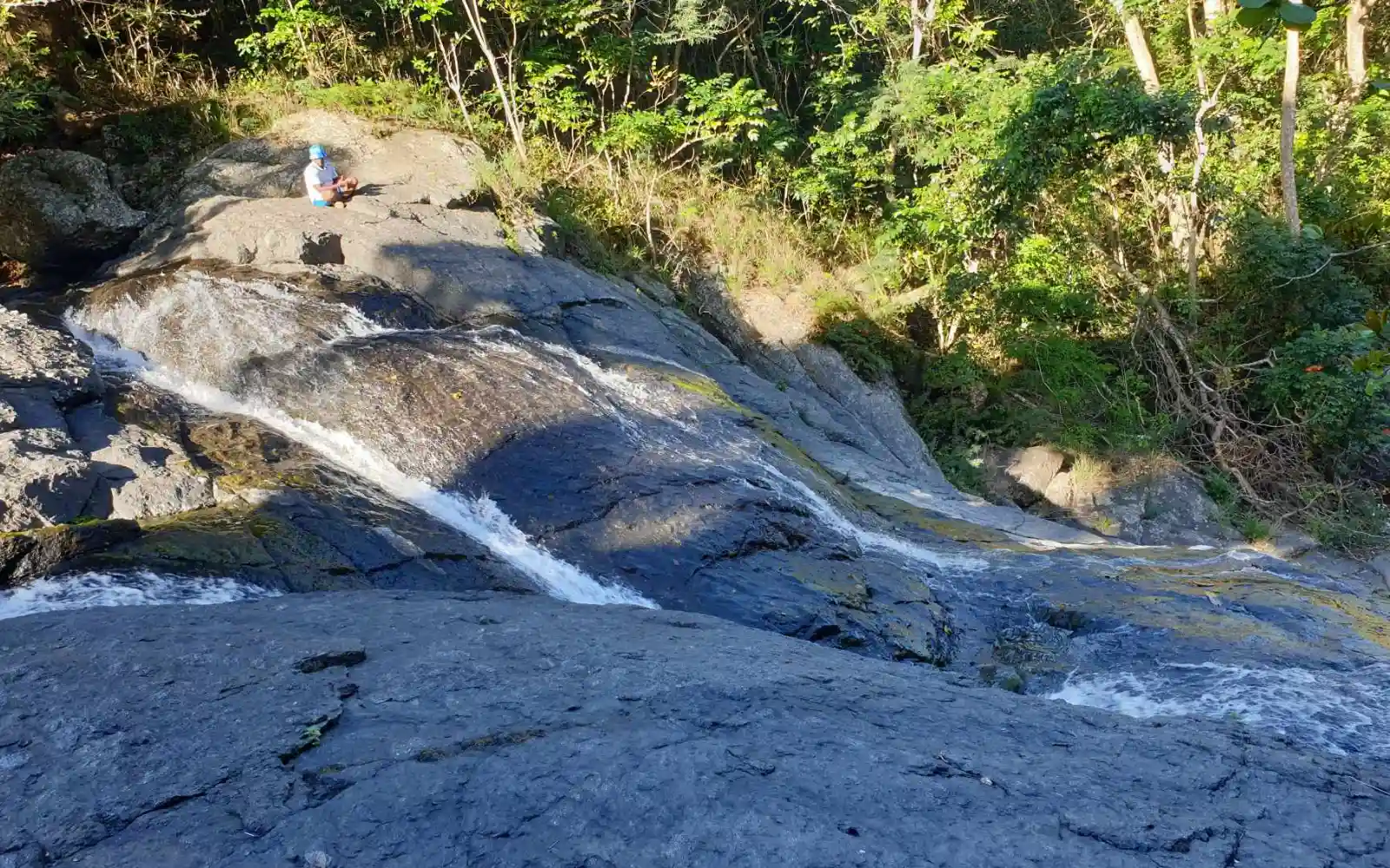 Hiker at a remote waterfall near Sigatoka, Fiji