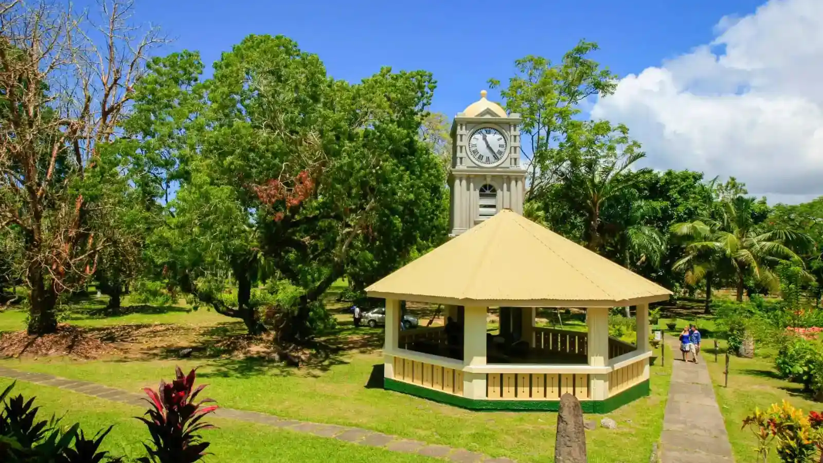 Shaded walking path winding through tall tropical trees and palm fronds in Thurston Botanic Gardens Suva
