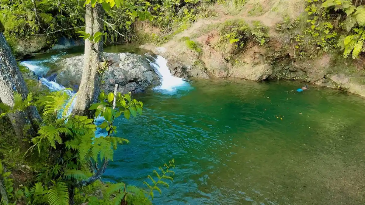 Rainforest cascade flowing into a natural freshwater pool in Fiji