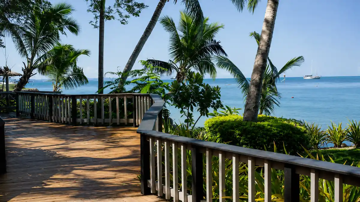 Wooden pier and shallow shoreline at First Landing Beach Resort during low tide near Vuda Marina