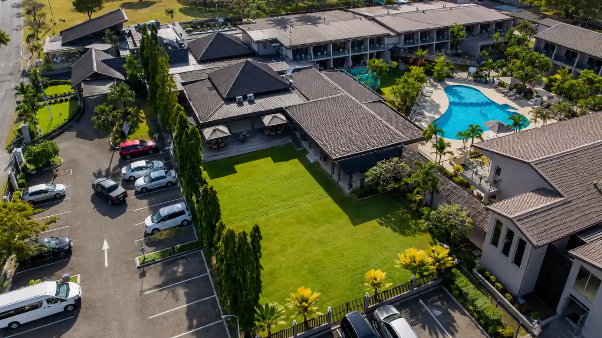 Outdoor swimming pool and tropical courtyard at Tanoa Waterfront Hotel in Lautoka