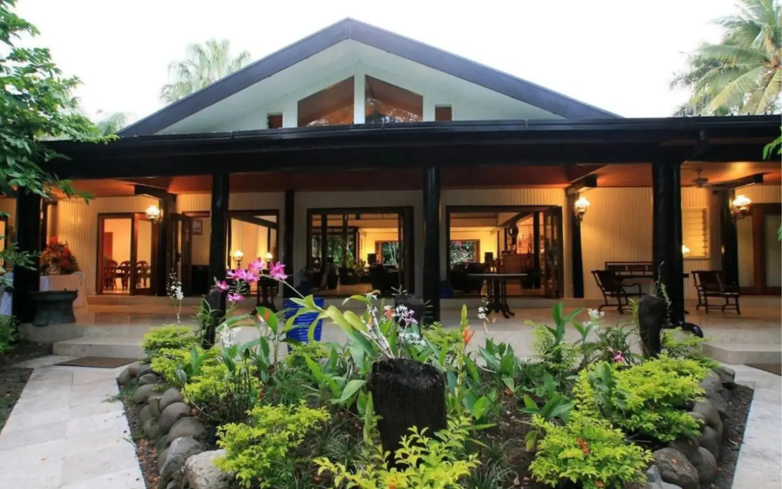 Tented garden bure at The Fiji Orchid surrounded by orchids and palms