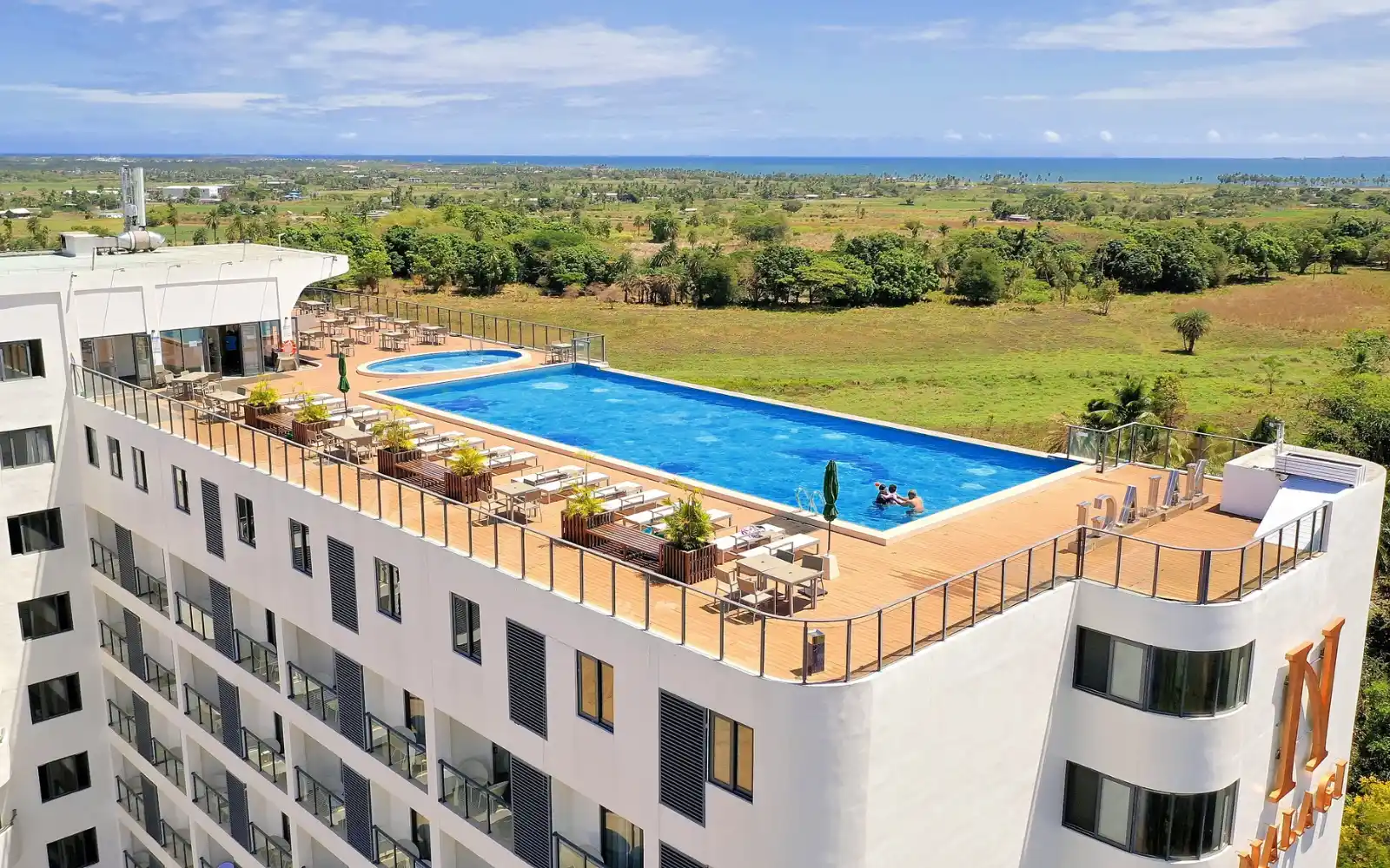 The refreshing rooftop infinity pool at Nalagi Hotel in Nadi, offering panoramic views of the ocean and surrounding landscape.