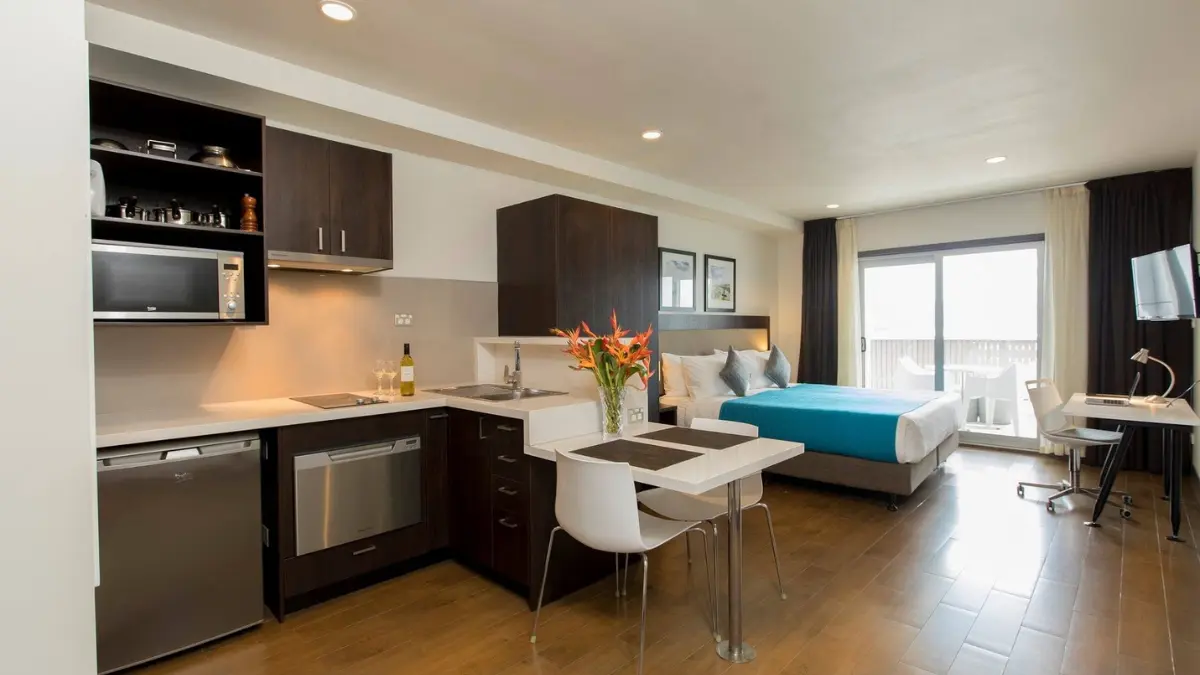 Studio apartment bedroom and dining space at Quest Suva.
