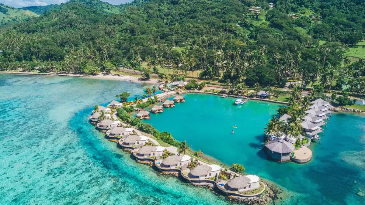 Open-air treatment bure surrounded by tropical plants at Koro Sun Resort's Rainforest Spa
