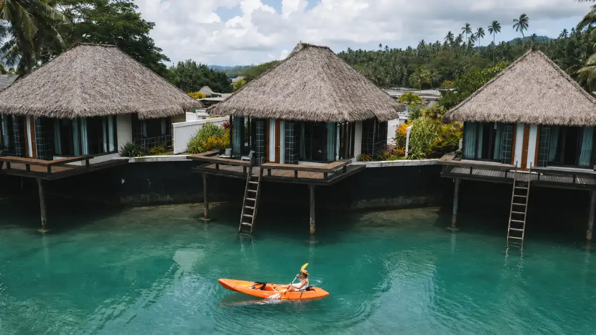 Floating bures and wooden walkways in the protected lagoon at Koro Sun Resort near Savusavu