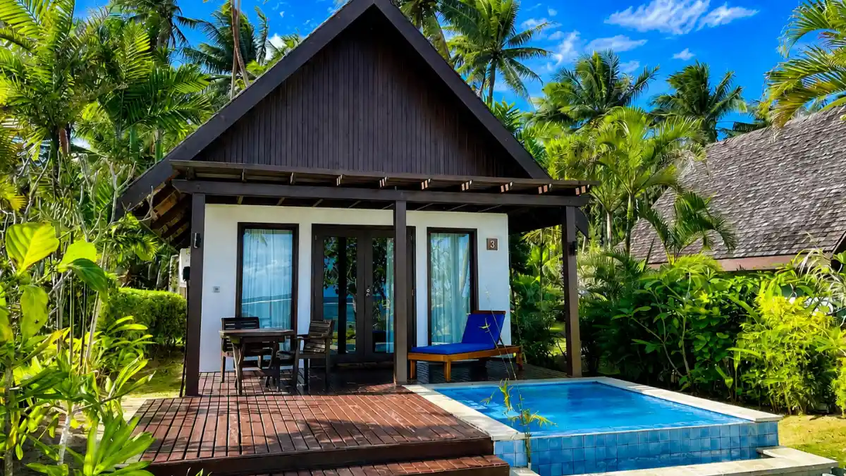 Beachfront bure and tropical shoreline at Tambua Sands Beach Resort on Fiji’s Coral Coast.