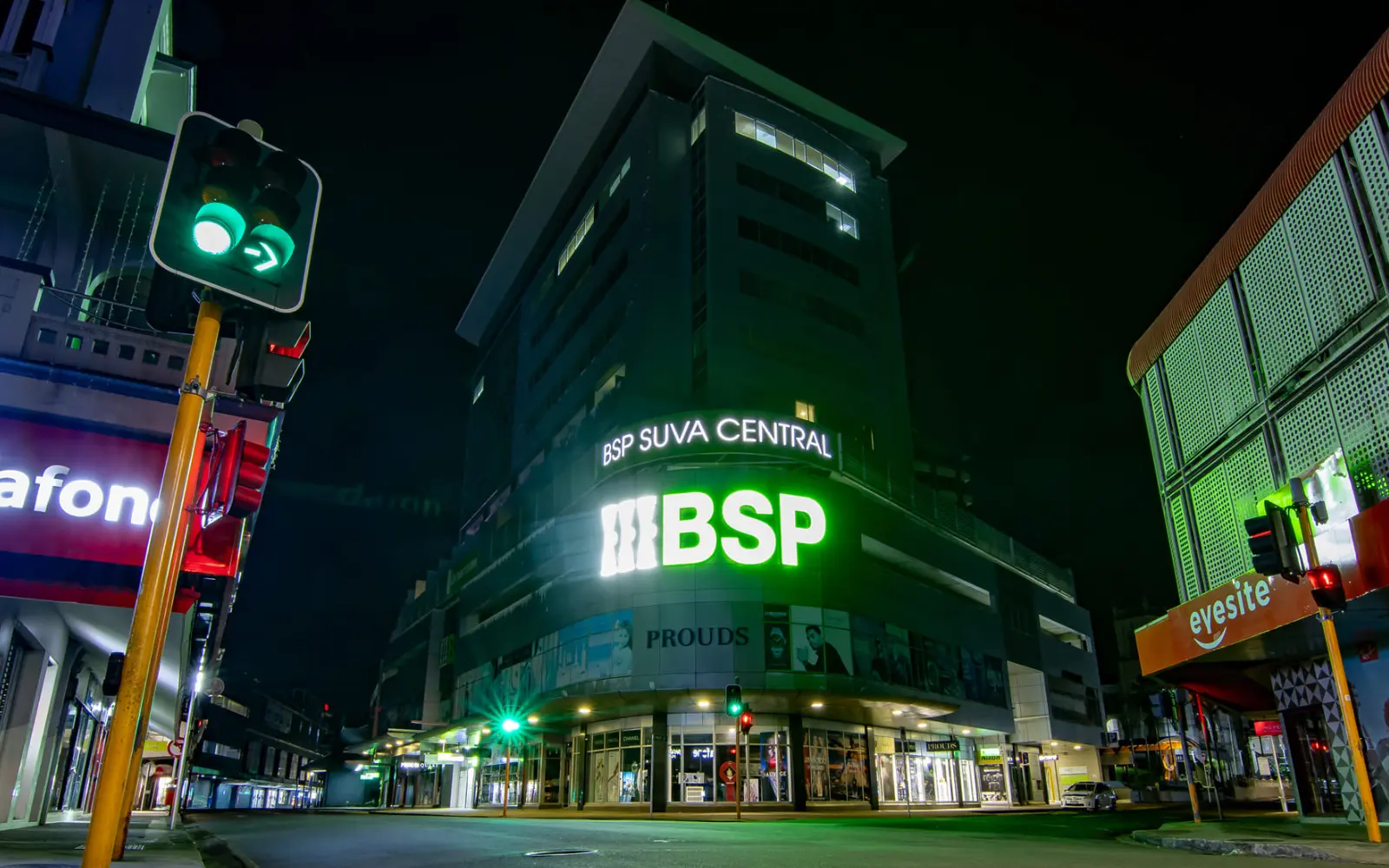 Suva city street with night lights and pedestrians walking safely