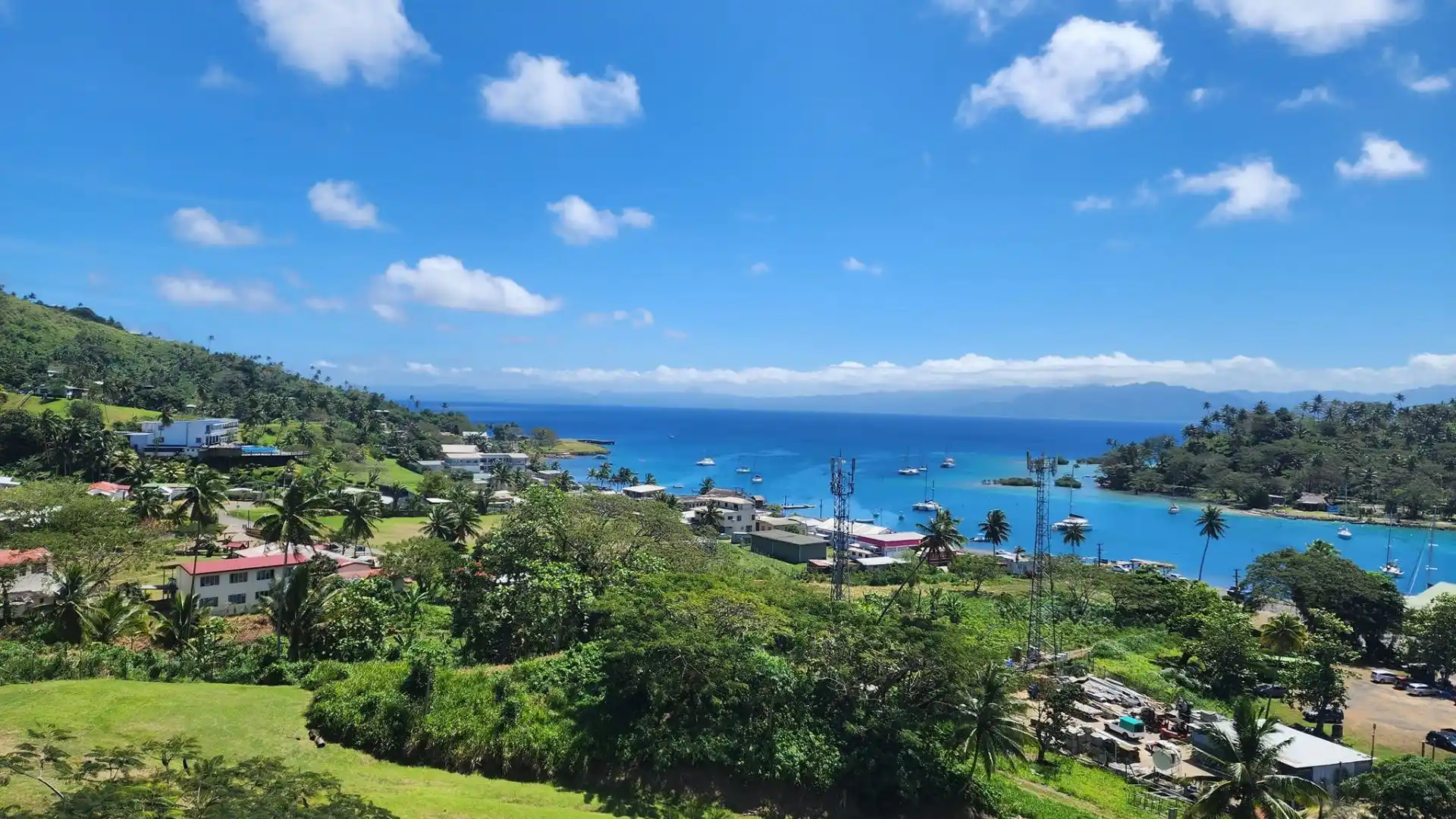 Savusavu Bay's calm waters with traditional Fijian boats and tropical coastline