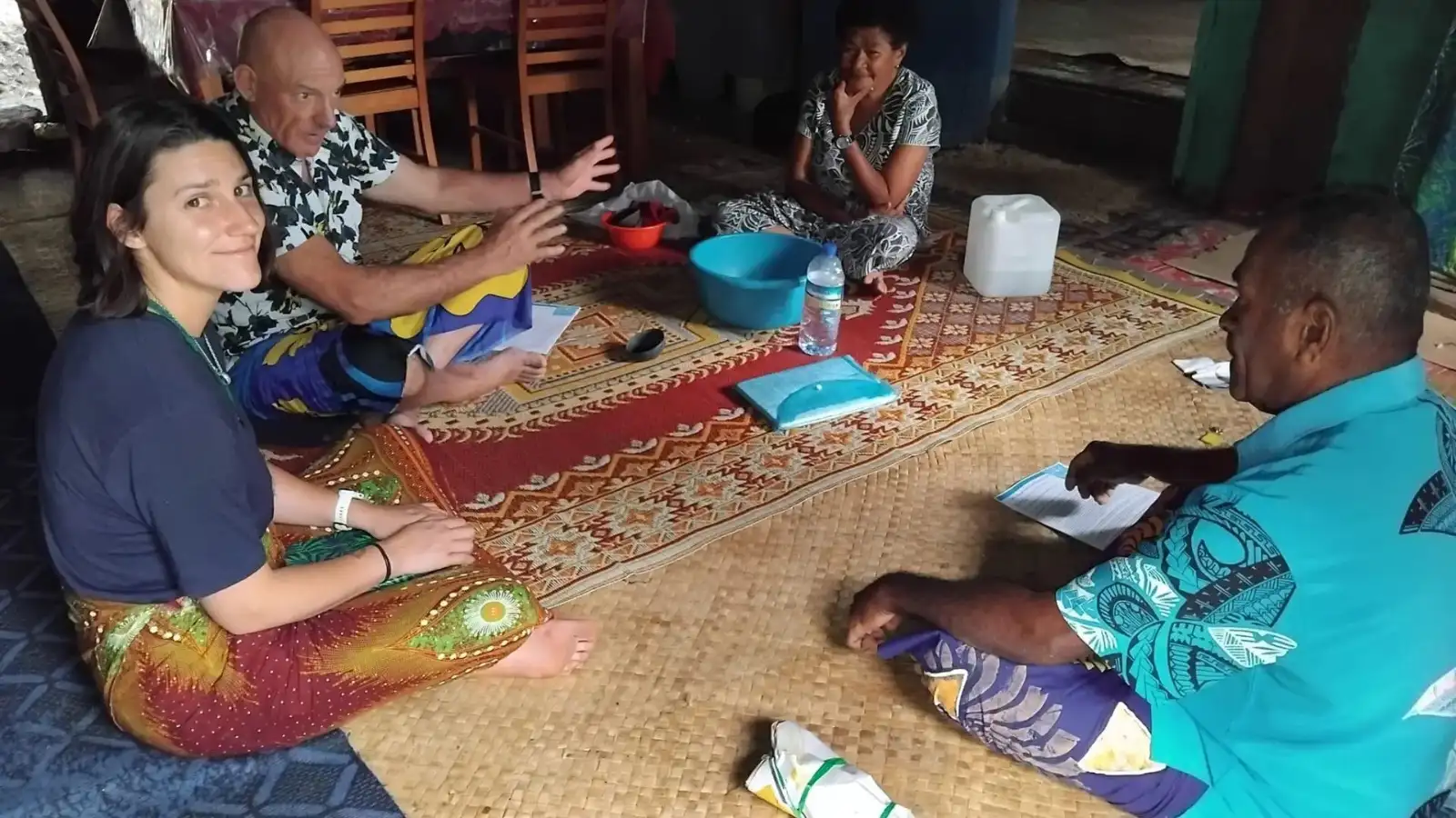 Authentic Fijian village homestay with traditional thatched bures and a local family welcoming visitors