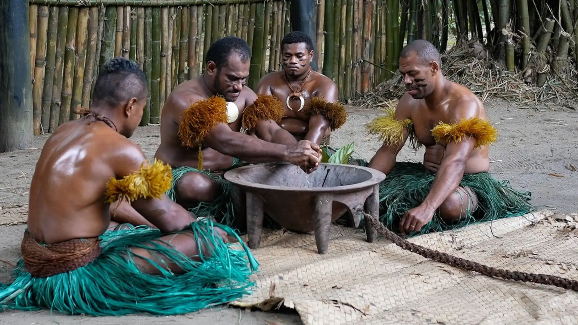Traditional Fijian Kava ceremony with village elders seated in circle around carved wooden tanoa bowl during sacred ritual