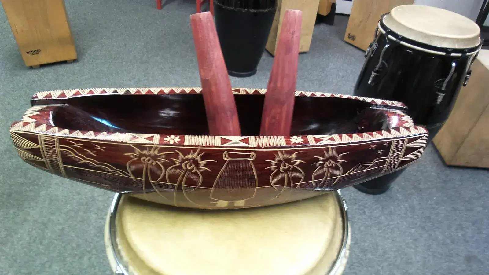 Traditional Fijian musicians performing with lali drums and bamboo flutes during a cultural ceremony surrounded by palm trees