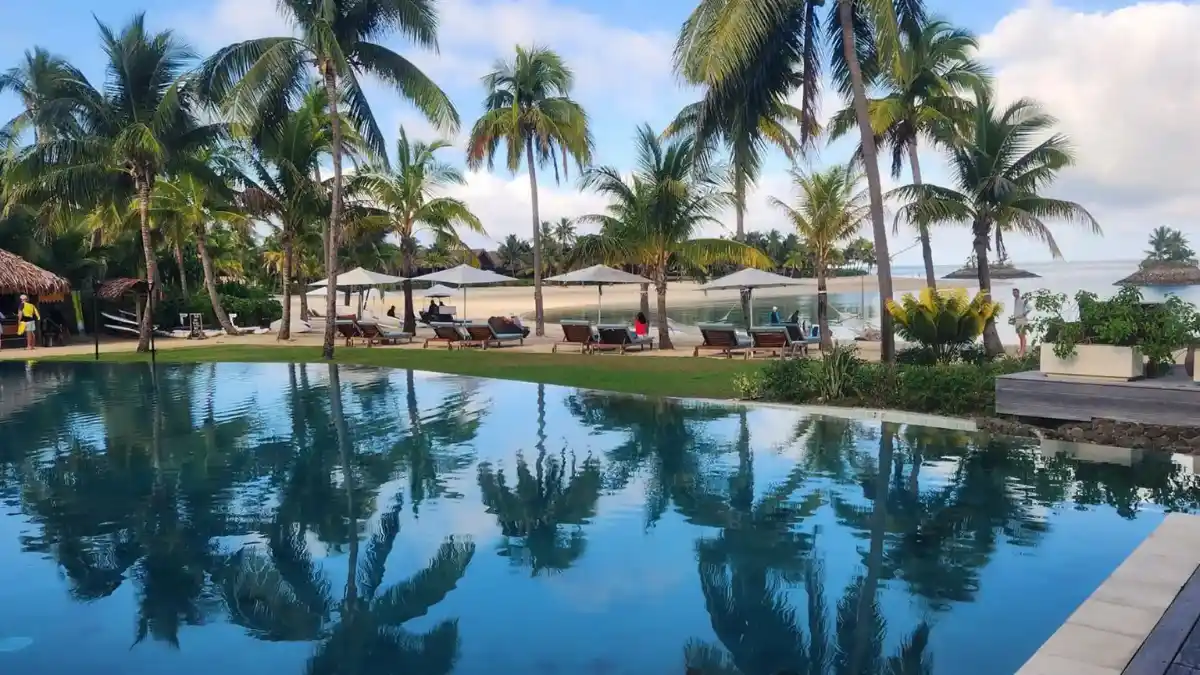 Six Senses Fiji eco-resort surrounded by palm trees and turquoise waters