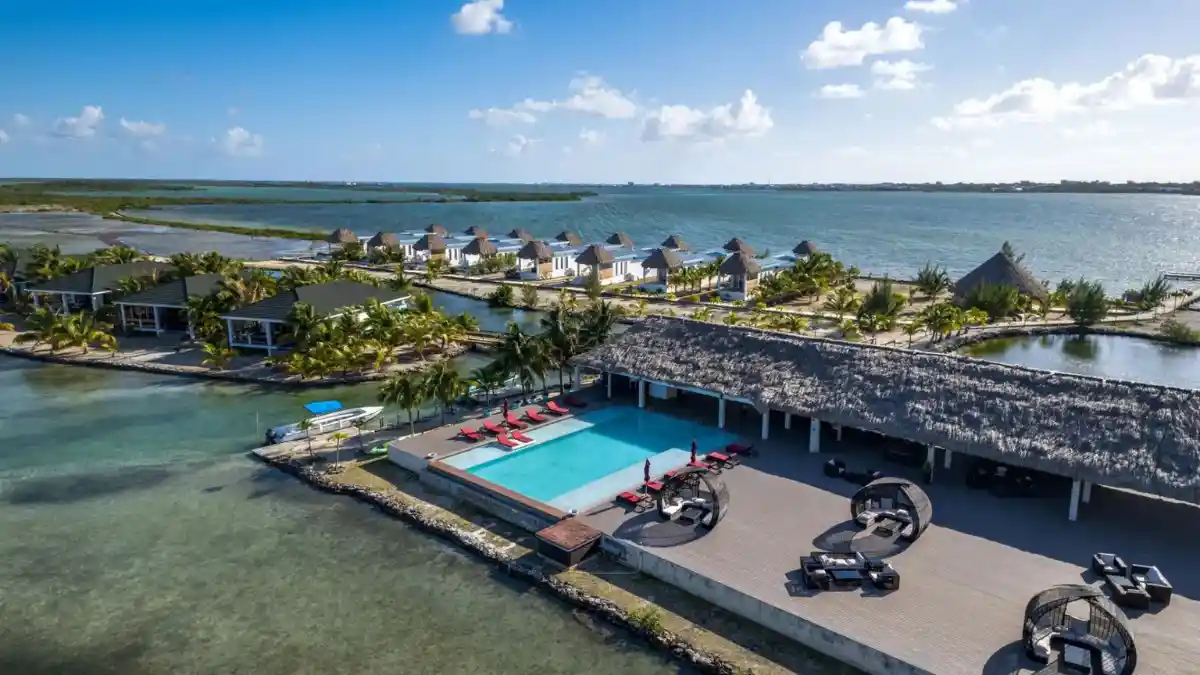 Turtle Island Resort beachfront villas surrounded by lush tropical greenery and crystal-clear water, offering eco-luxury in Fiji's Yasawa Islands.